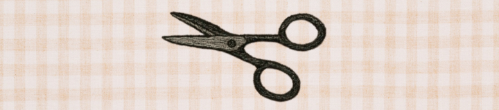 Embroidered embroidery scissors on checkered background
